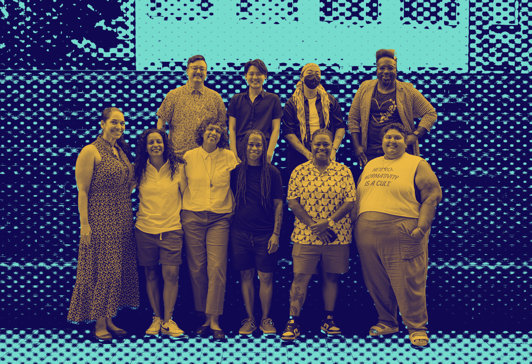 Duotone image of ten NQTTCN members, including the Founding Director Erica Woodland, pose together at a regional gathering. They are outside, standing in front of a striped wooden relief.